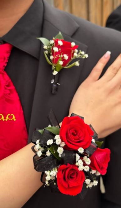 Red rose boutonniere and matching black wrist corsage for prom