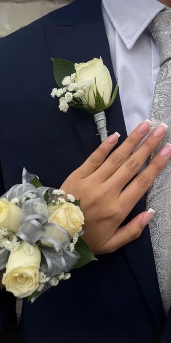 White rose boutonniere and silver-ribboned wrist corsage