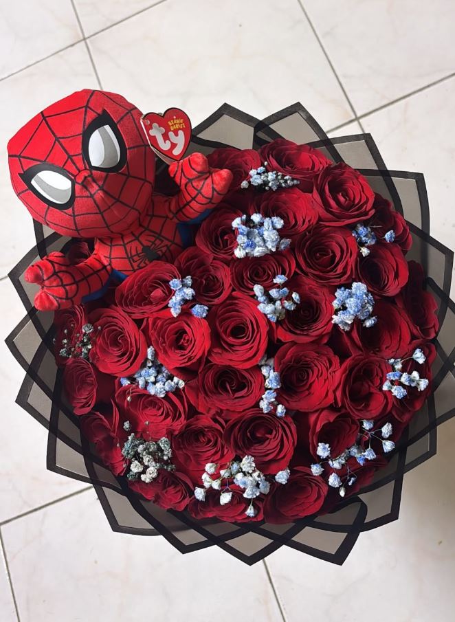 Red rose bouquet with a Spider-Man plush toy tucked in